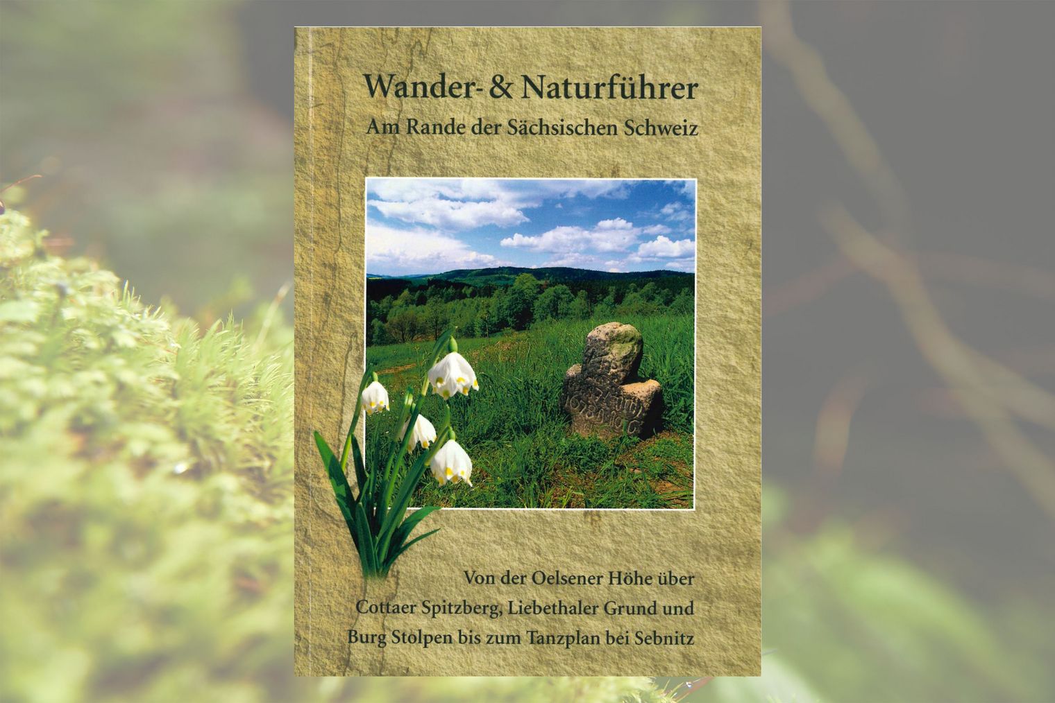 Buchcover mit Titel "Wander- und Naturführer" und einem Bild von grünen Wiesen und weißen Märzenbecherblüten.