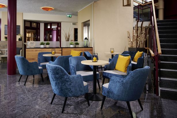 Moderne Hotellobby mit gemütlichen Sitzgelegenheiten und Pflanzen.